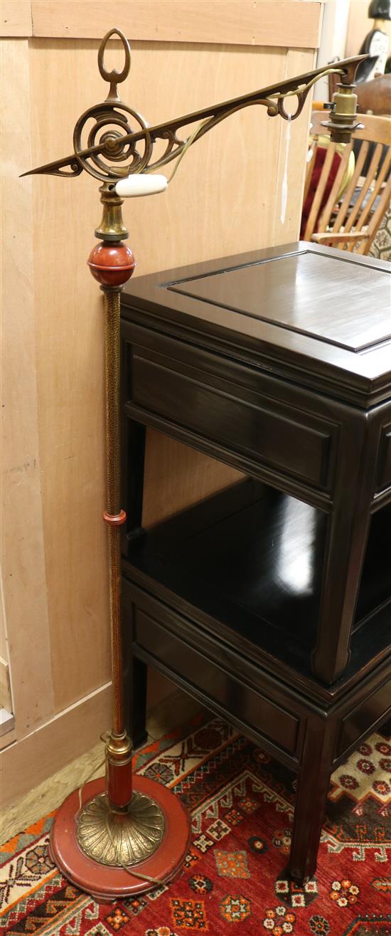 A late Victorian red painted cast iron and hammered brass lamp standard